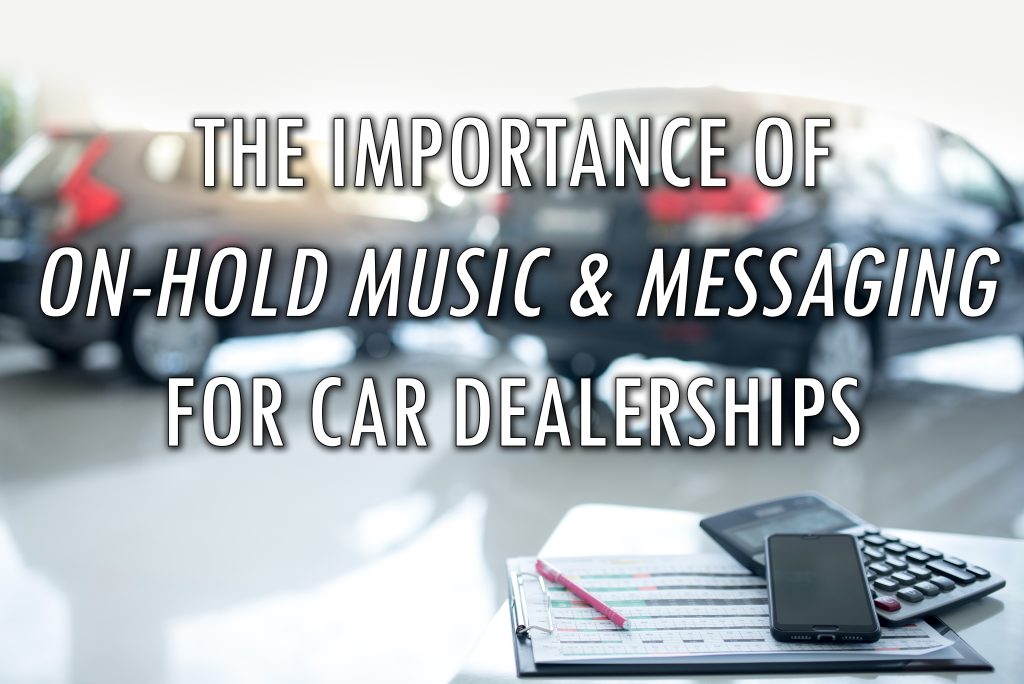 The Importance of On-Hold Marketing for Car Dealerships - Title Card - out of focus car dealership showroom with desk, phone and clipboard in focus in foreground and the title superimposed over top