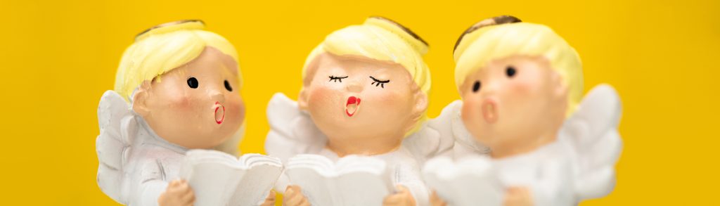 Image of porcelain singing cherubs or angels to convey the concept of Christmas carols beginning as religious songs and becoming more common secular music